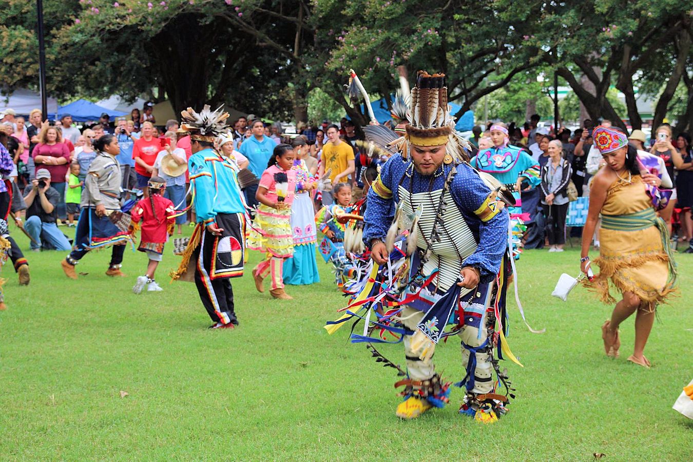 Native Lumbee men and women dance in traditional dressings during a performance at the Lumbee POWWOW in Lumberton, North Carolina. 