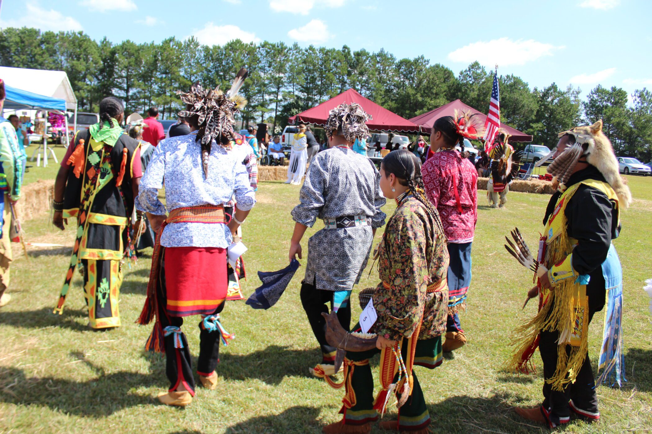 Several Lumbee Tribe members dance dressed in traditional garb at the Lumbee Tribe POWWOW in Lumberton, North Carolina.