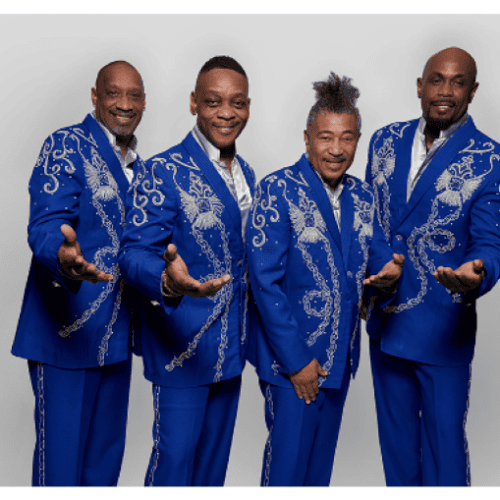 A group of men in a singing group all dressed in bright blue suits with their hands extended towards the viewer.